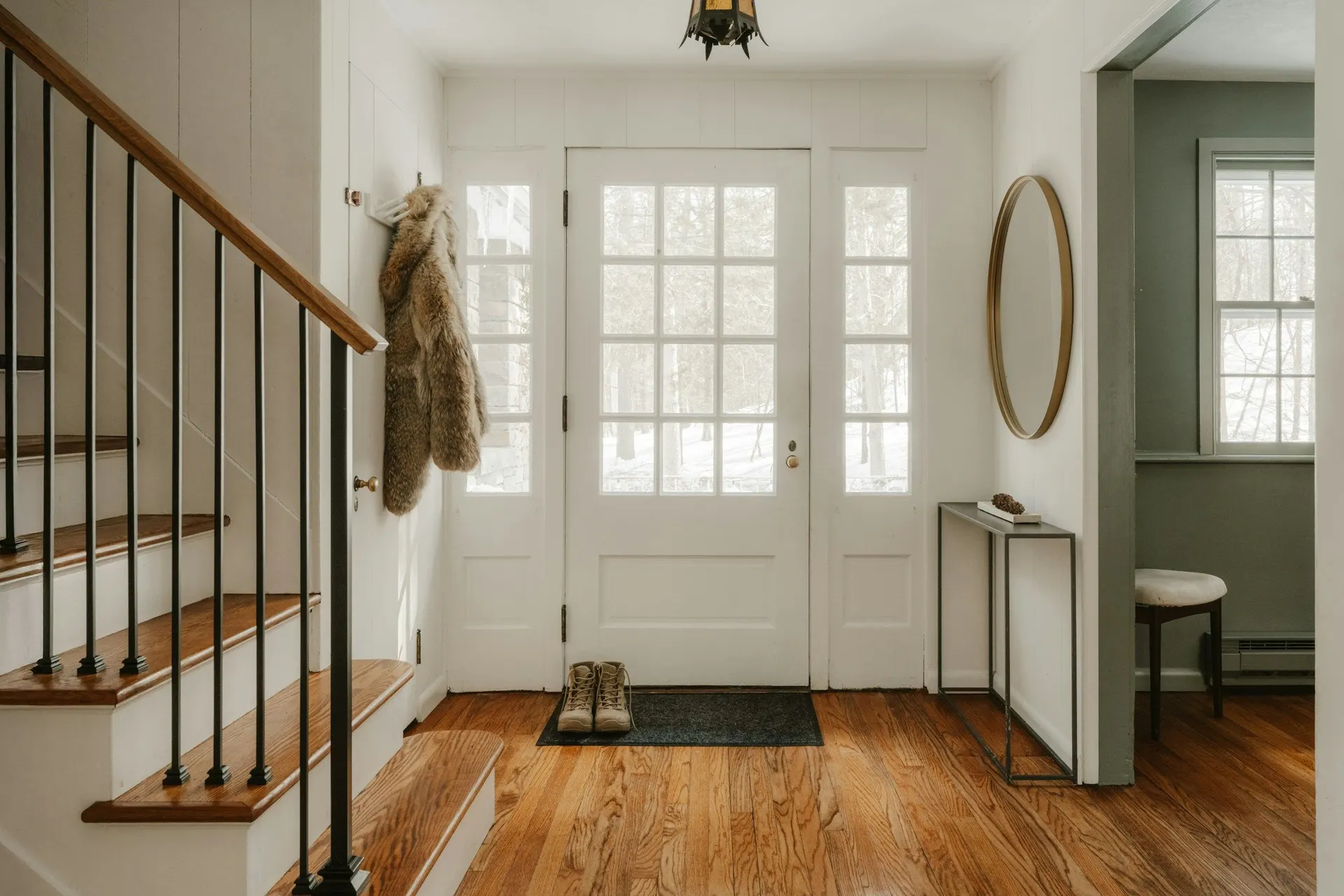 A bright front hall with light coming through the glazed front door
